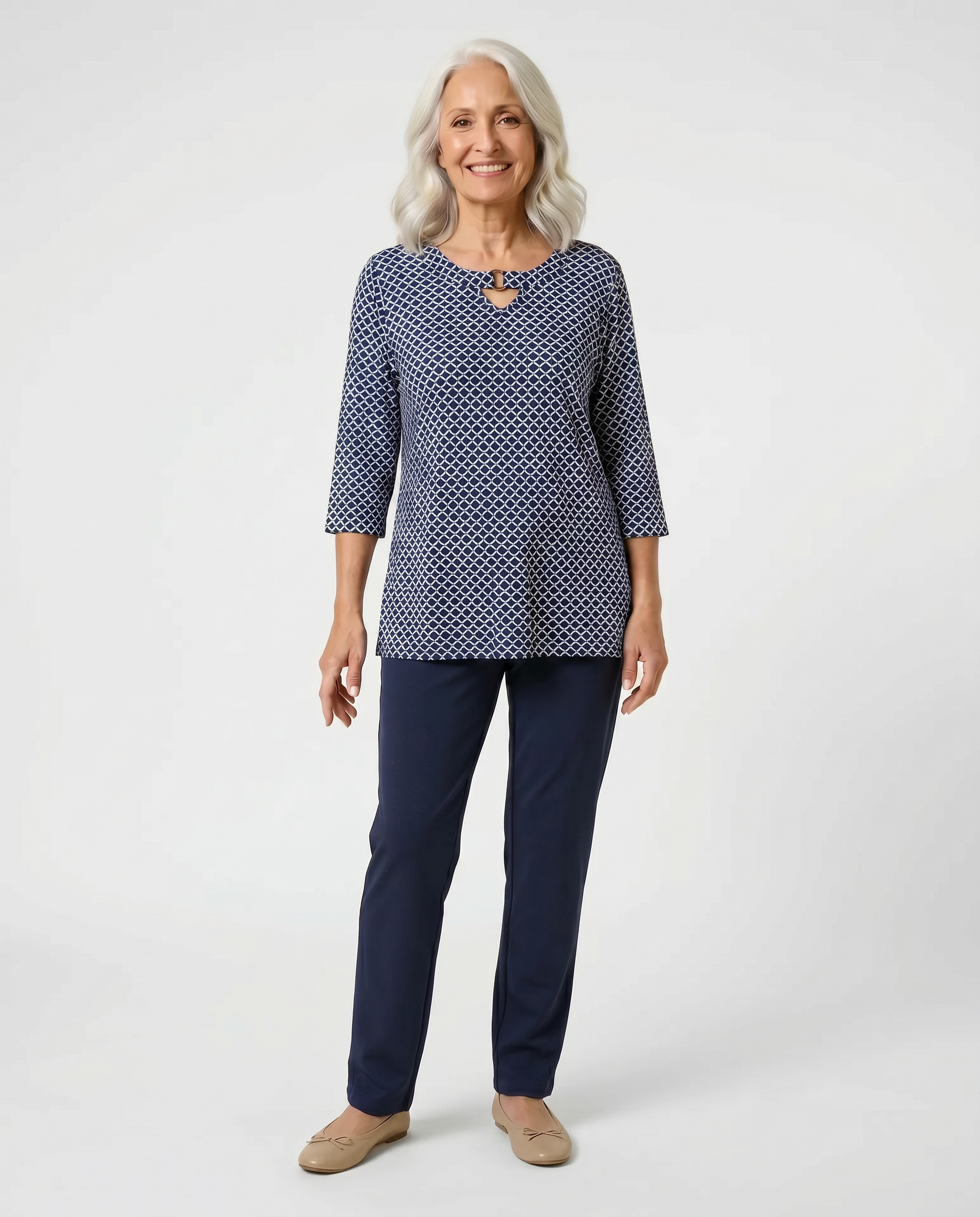 Senior woman wearing Ovidis adaptive navy patterned knit top with ring neckline detail, easy dressing