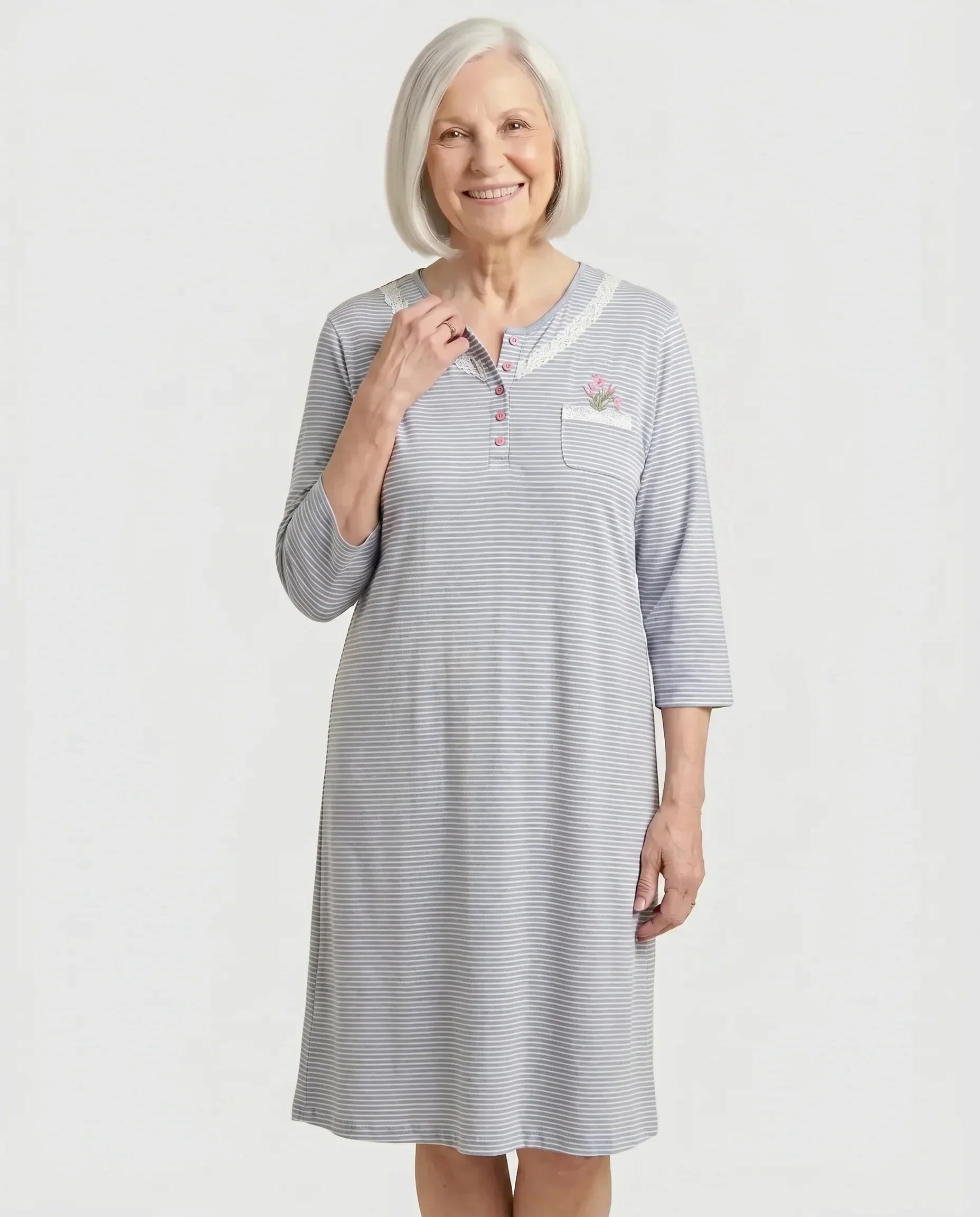 Senior woman wearing Nikky Nightgown in Blue grey stripe with tulip embroidery, front view