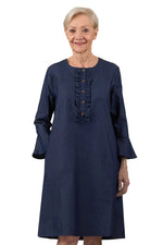 Senior woman wearing adaptive denim dress with ruffled button placket and long sleeves