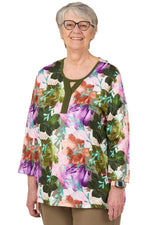 Smiling senior woman wearing Ovidis adaptive floral shirt in olive, ideal for easy dressing