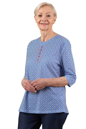 Senior woman wearing adaptive blue patterned shirt with front buttons, three-quarter sleeves