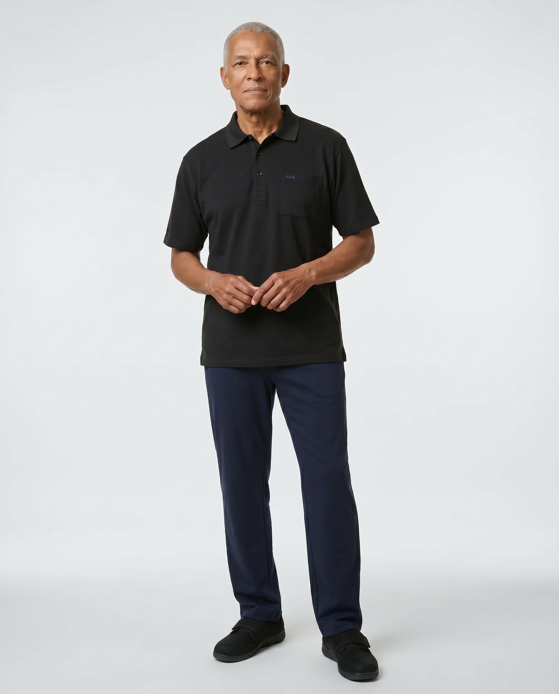 Senior man wearing Ovidis adaptive black polo shirt