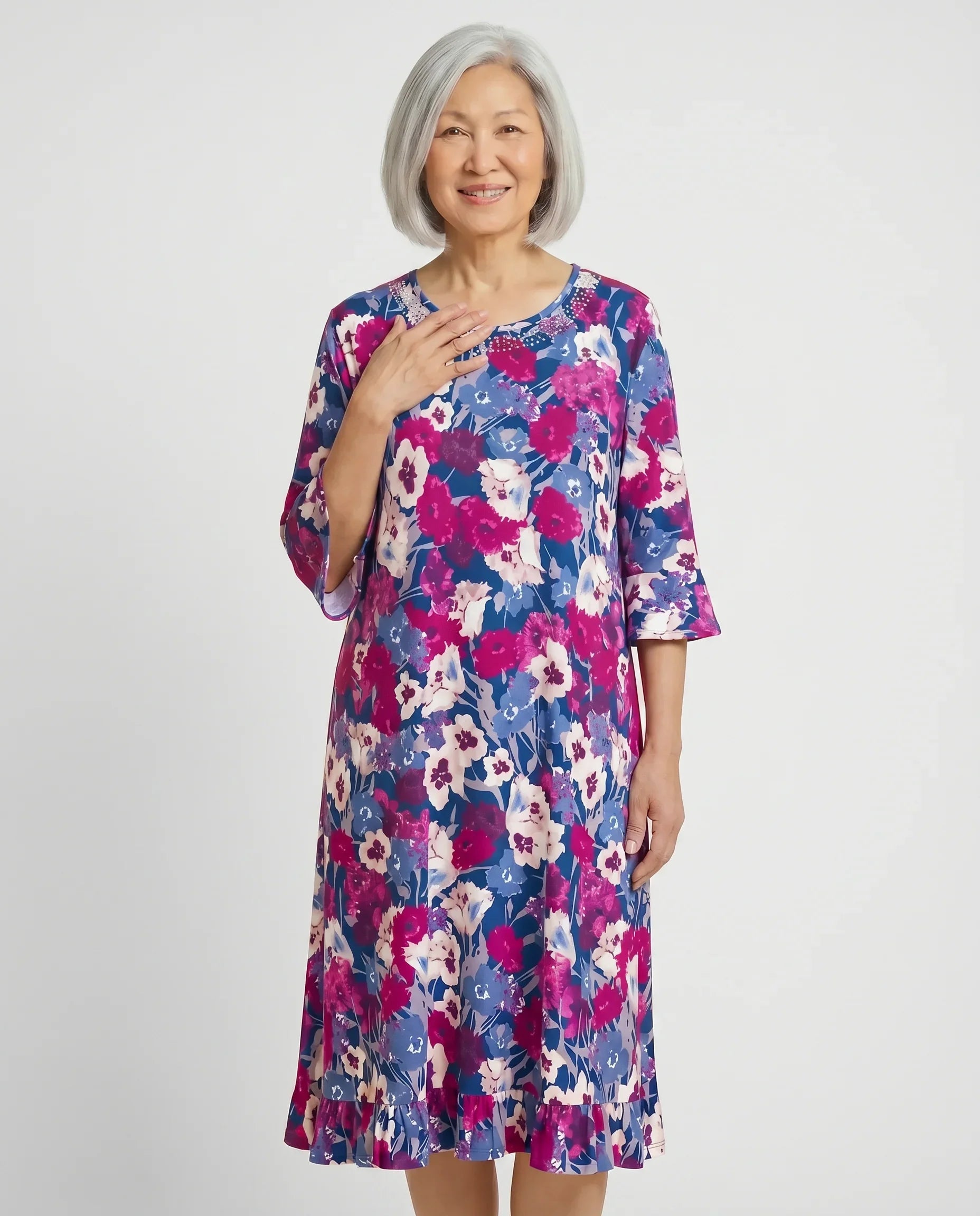 Senior woman wearing Romei Fushia adaptive floral dress with bell sleeves, front view