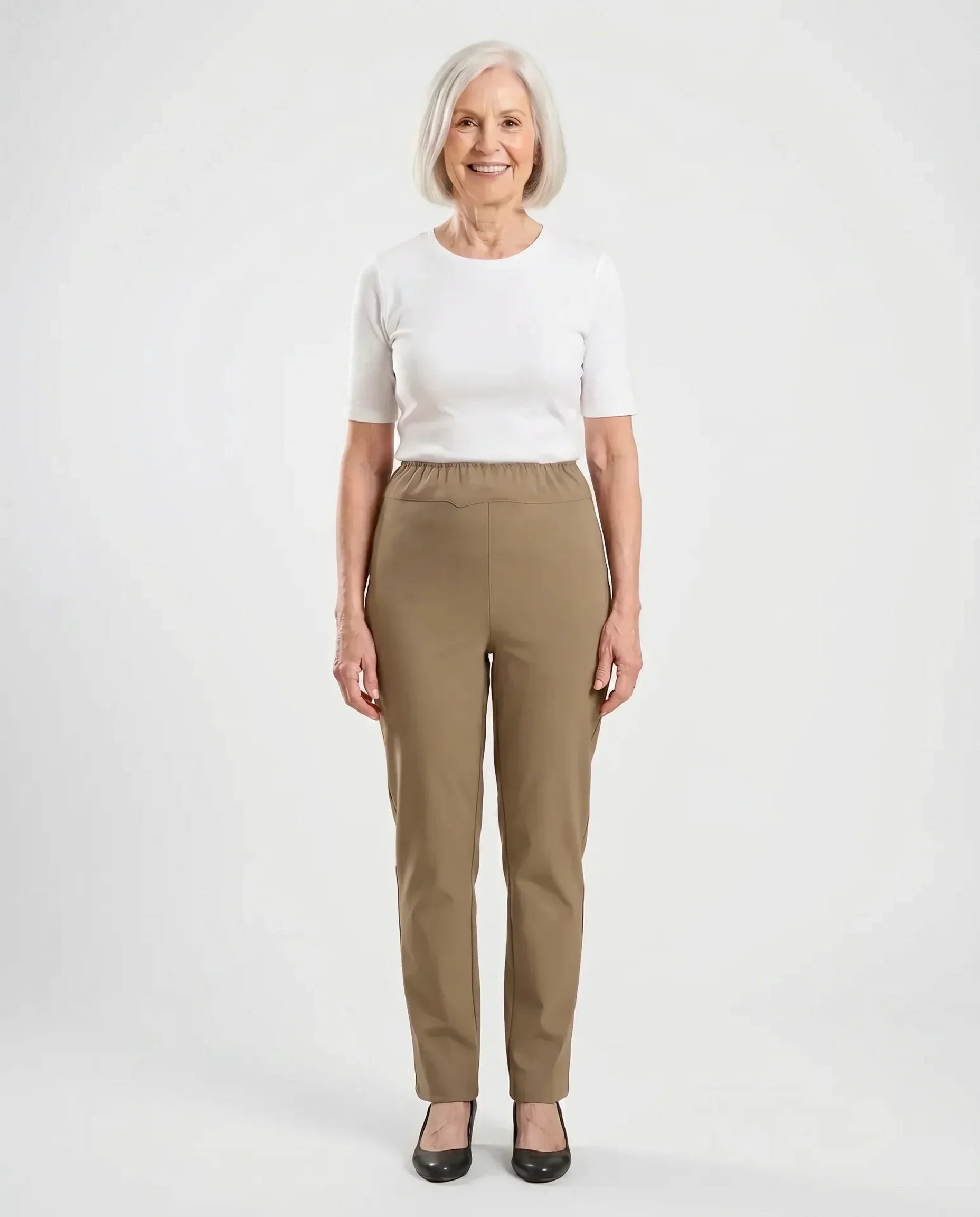 Senior woman wearing Ovidis Sara Pants in Tan, full body front view