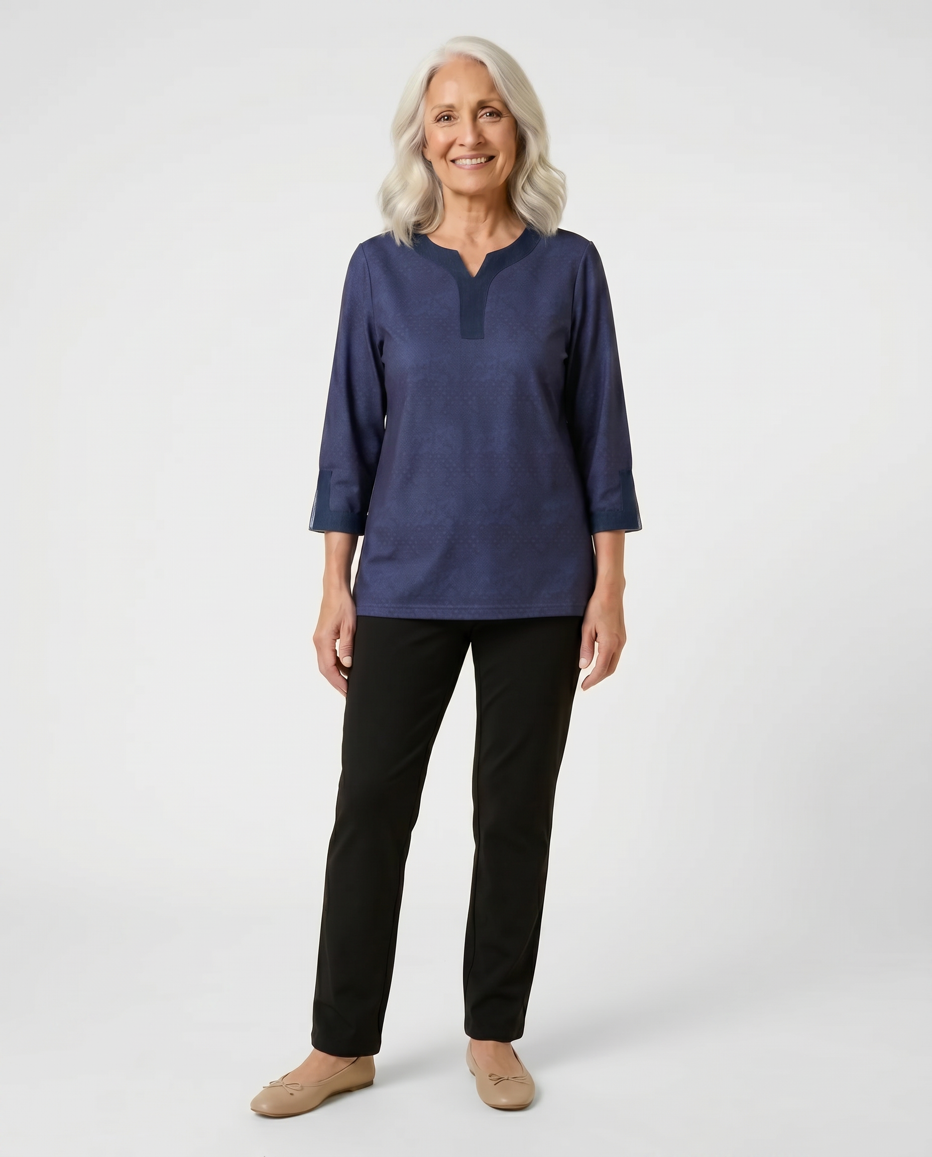 Senior woman wearing adaptive navy tonal-print top with contrast denim collar and cuff trim, paired with black pants