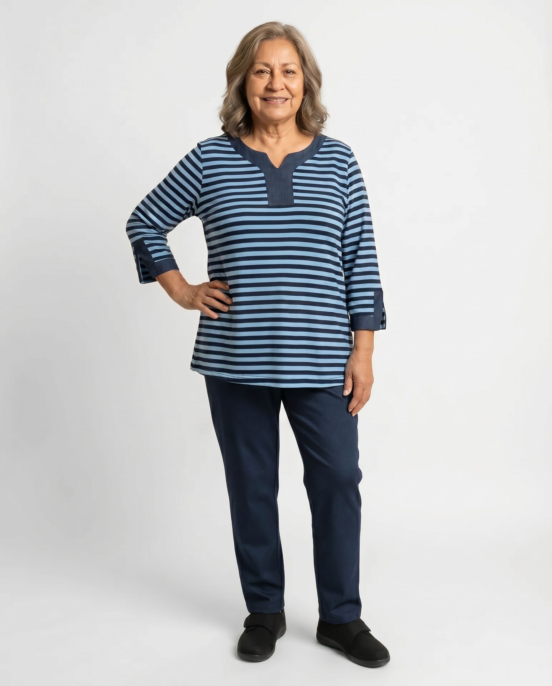 Senior woman wearing Ovidis adaptive navy striped top with denim collar and cuff detail, easy dressing
