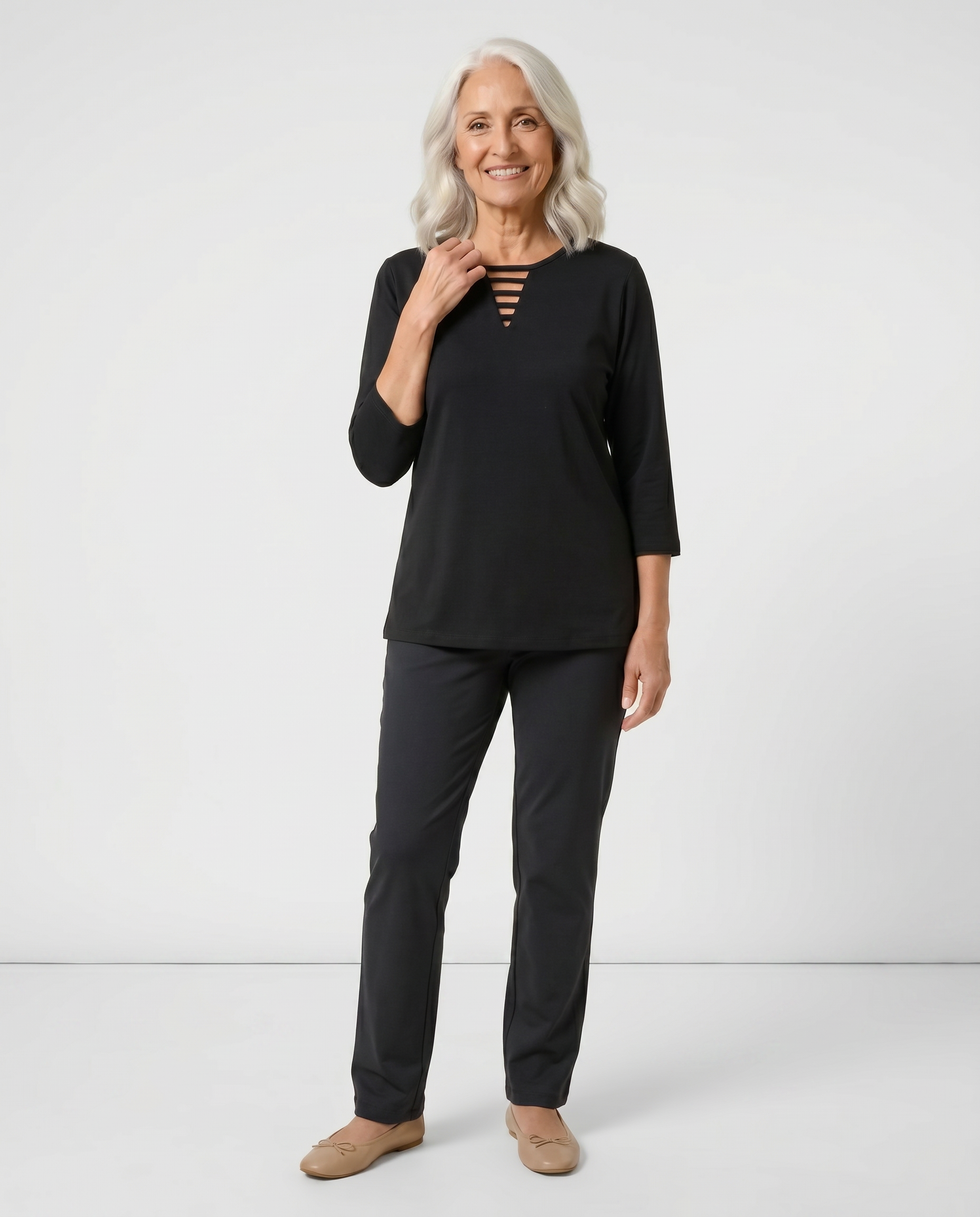 Senior woman wearing Ovidis adaptive black top with triangular ladder cutout neckline, easy assisted dressing