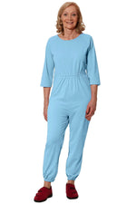 Senior woman wearing light blue adaptive jumpsuit, Ovidis dementia clothing, front view
